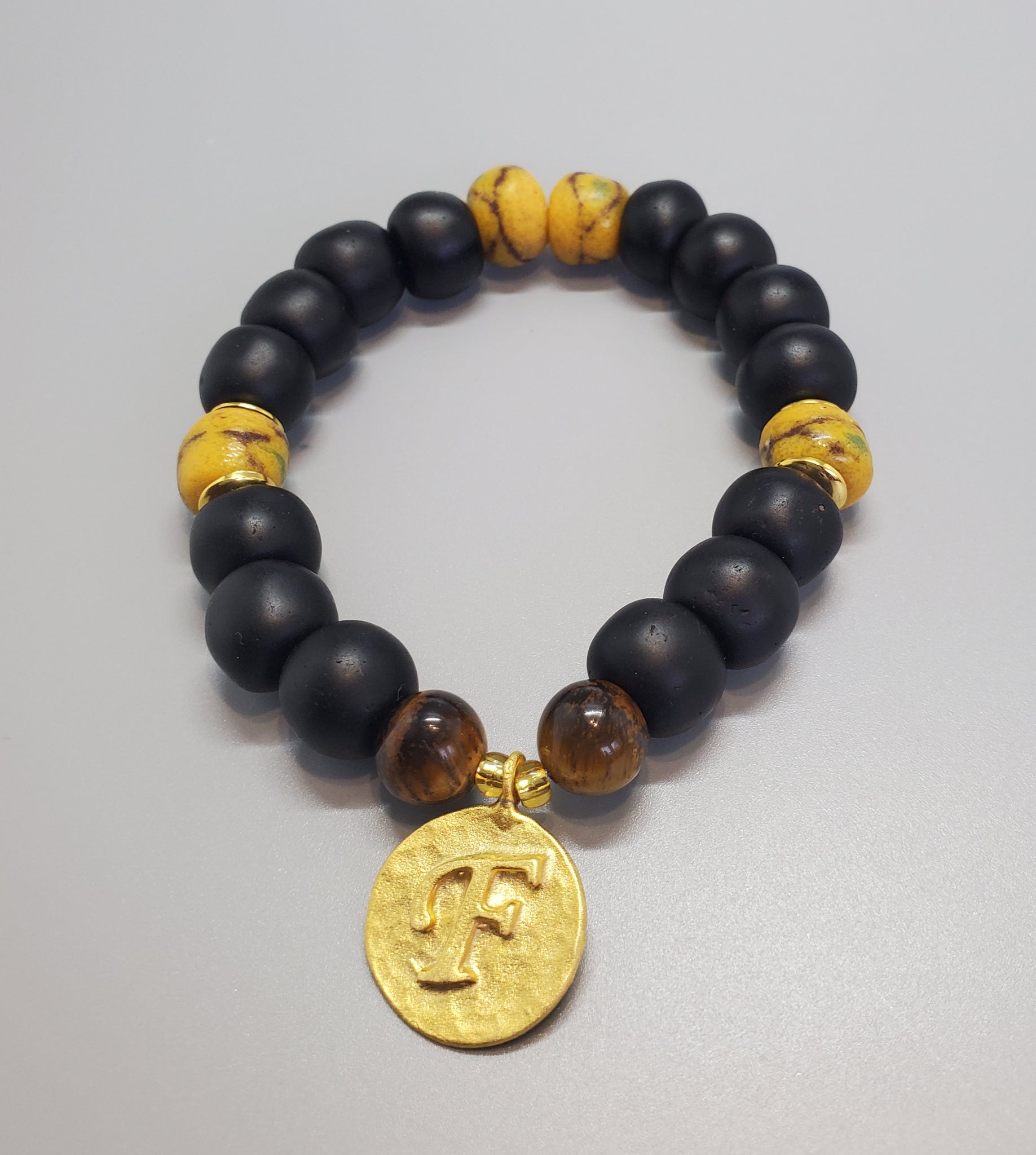 Black, Must. Krobo Beads, Tiger Eye, 22K Gold Plated Plated Brass "F" Charm, Brass, Unisex Stretch Bracelet